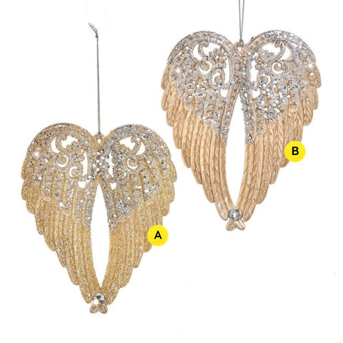 Two glittered angel wing ornaments in champagne and platinum finishes with scroll details, feather texture, and faceted jewel accents.