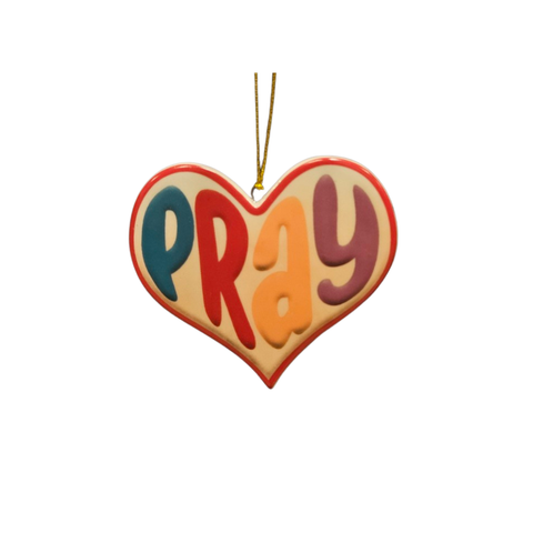 Heart-shaped ornament with the word Pray in bold multicolor lettering and a red border.
