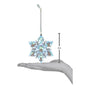 Decorative snowflake ornament with a measurement indicator showing its size on a hand.