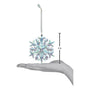 Decorative snowflake ornament with measurement against a hand