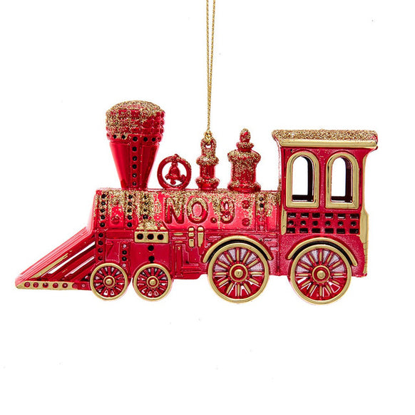 Red and gold train ornament shaped like a vintage locomotive with glittered accents, detailed wheels, and a gold hanging cord.