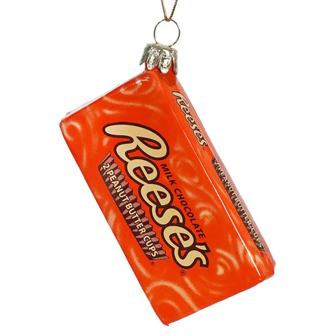 Ornament shaped like a Reese’s Peanut Butter Cups candy package in bright orange with the Reese’s logo on the front.