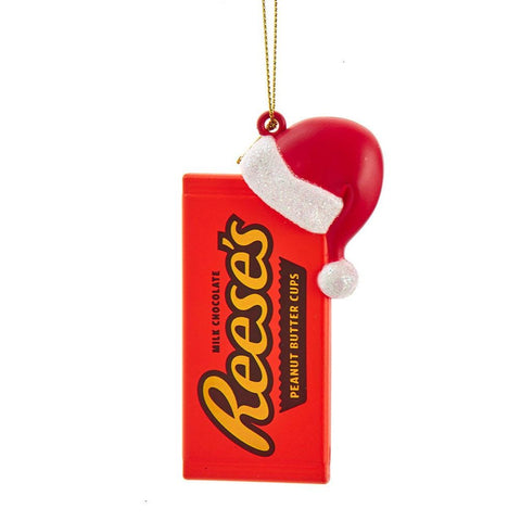 Reese’s™ peanut butter cups candy bar ornament with a red Santa hat and glittery white trim, hanging from a gold cord.