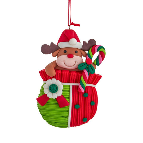 Reindeer ornament wearing a Santa hat and peeking out of a red and green gift bag while holding a colorful candy cane.