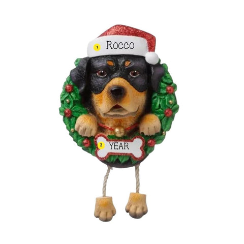 Personalized Rottweiler ornament with a black and tan dog in a Santa hat peeking through a green wreath with space for a name and year.