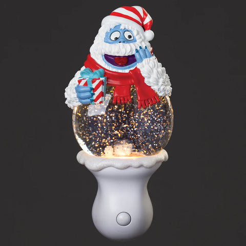 Rudolph Bumble Swirl Night-Light featuring Bumble in a Santa hat above a glowing glitter-filled globe while holding a candy-striped gift