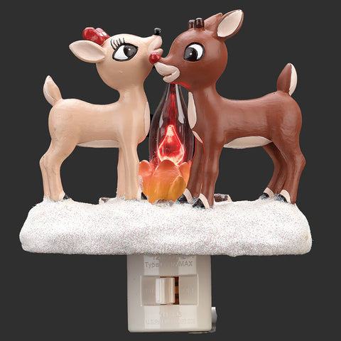 Rudolph and Clarice standing nose to nose beside a glowing flickering campfire on a glittered snow-covered night-light base