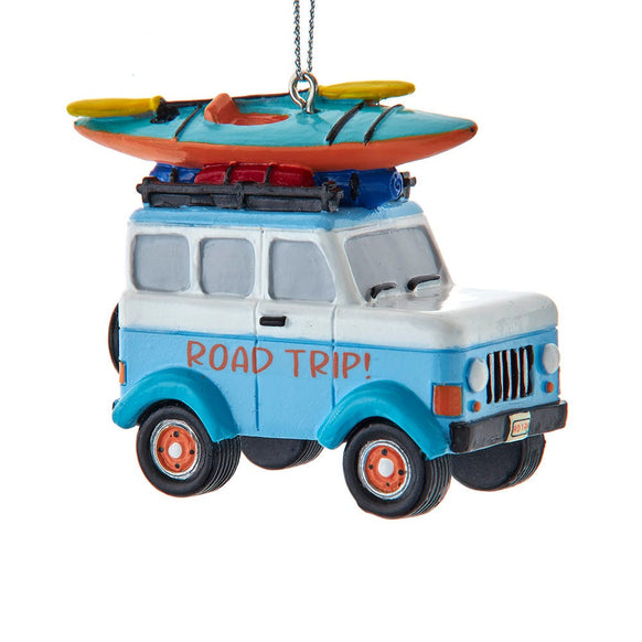 Road Trip ornament featuring a blue and white vintage-style SUV with a kayak and travel gear strapped to the roof.