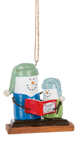 S’mores Story Time ornament featuring two marshmallow snowman-style figures in pajamas on a graham cracker base, reading a red Christmas book together.