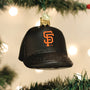 Black baseball cap ornament with Giants orange logo on a Christmas tree.
