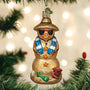 Decorative Christmas ornament of a sand snowman wearing sunglasses and a hat, hanging on a Christmas tree.