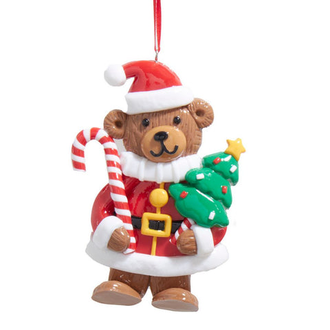 Bear ornament dressed in a red Santa coat and hat, holding a red and white candy cane and a green Christmas tree.