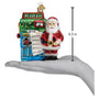 Christmas ornament of Santa Claus with a AI Bot list machine, held in a hand for scale.