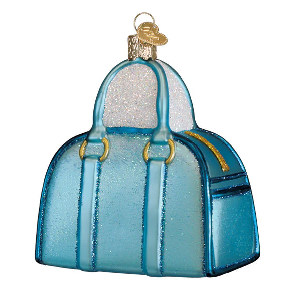 Blue handbag ornament with gold accents on a white background