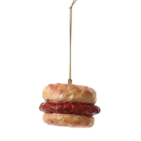 Sausage breakfast sandwich ornament with a biscuit-style bun and sausage patty hanging from a gold cord.