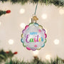 Decorative ornament with 'Happy Easter' text hanging on a Christmas tree.