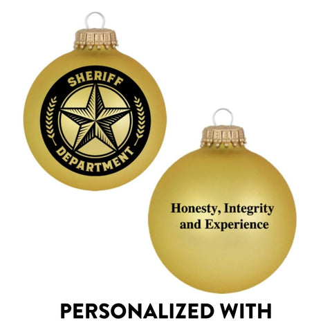 Gold glass Sheriff Department bulb ornament with black emblem and printed message on back, shown as a personalized Christmas ornament.