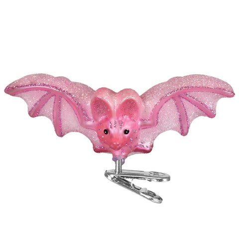 Pink glittery bat-shaped clip on a white background