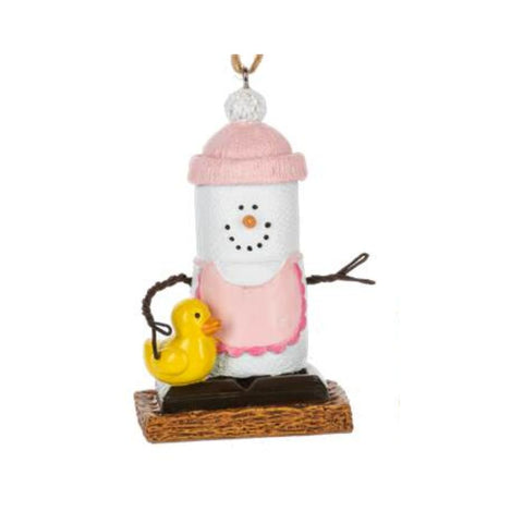 Baby girl Christmas ornament with a marshmallow snowman figure, pink winter accessories, twig arms, and graham cracker-style base details.