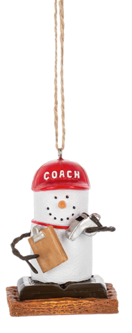 S’mores coach ornament featuring a marshmallow character wearing a red COACH hat, holding a clipboard and whistle, and standing on a graham cracker base.