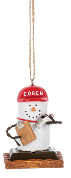 S’mores coach ornament featuring a marshmallow character wearing a red COACH hat, holding a clipboard and whistle, and standing on a graham cracker base.