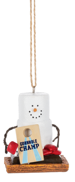 S’mores Cornhole Champ ornament featuring a marshmallow snowman with pretzel stick arms, a cornhole board that reads “Cornhole Champ,” red bean bags, and a graham cracker base.
