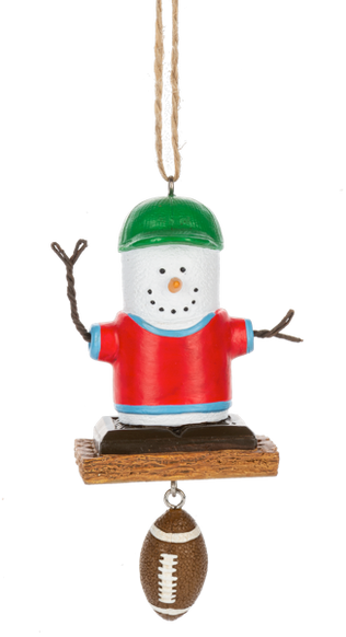 S’mores Football Fan ornament featuring a marshmallow character in a red shirt and green cap with a dangling football accent.