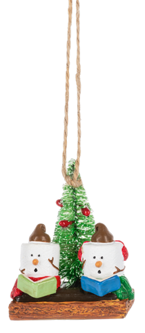 Christmas ornament with two marshmallow singers, a small green tree, red earmuffs, songbooks, and graham cracker base details.
