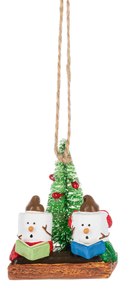Christmas ornament with two marshmallow singers, a small green tree, red earmuffs, songbooks, and graham cracker base details.