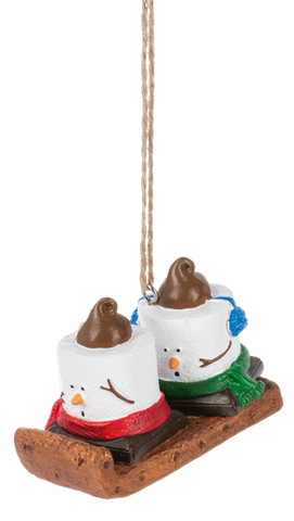 Mini S’mores Toboggan ornament featuring two marshmallow characters riding a brown sled with red and green scarves and blue earmuffs.