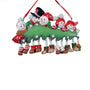 Snowman family of 5 ornament with five smiling snowmen gathered around a decorated Christmas tree with dangling legs and space for a family name or short phrase and year.