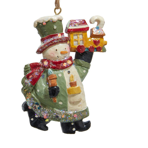 Glittered snowman ornament holding a yellow toy train with twine hanger