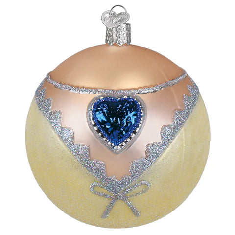 Decorative Christmas ball ornament with blue heart and silver accents on a beige background