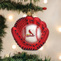 Red baseball glove ornament with a ball inside, featuring a Cardinal logo, on a Christmas tree.