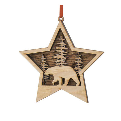 Layered wood star ornament with a bear silhouette, pine trees, snowy accents, and a red ribbon hanger.