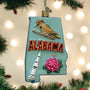 Decorative ornament shaped like Alabama with a woodpecker, rocket, and rose on a Christmas tree.