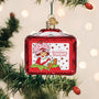 Strawberry Shortcake ornament on a Christmas tree with lights in the background