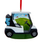 Golf cart ornament with a golf course scene in the window, blue golf bag, clubs, red hanging ribbon, and green base.