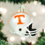 Decorative football helmet ornament with 'T' logo on a Christmas tree.