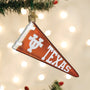 Decorative ornament shaped like a Texas Pennant hanging on a Christmas tree.