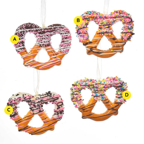 Twisted pretzel ornaments in four dessert-inspired styles with icing drizzle, sprinkles, and chocolate-style details, sold separately.