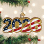 2026 Christmas ornament with American flag design hanging on a tree.