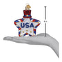 Star-shaped ornament with 'USA' text on a hand, showing its size.