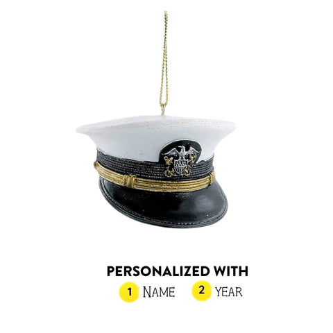 Personalized U.S. Navy officer cap ornament with white top, black brim, gold band, emblem detail, and gold hanging cord.