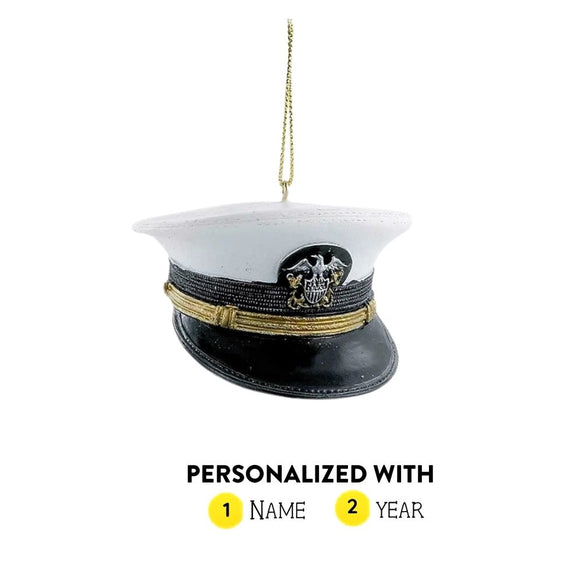 Personalized U.S. Navy officer cap ornament with white top, black brim, gold band, emblem detail, and gold hanging cord.
