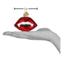 Glass ornament shaped like red vampire lips with a hand holding it to show size.