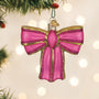 Pink bow ornament on a Christmas tree with blurred lights in the background
