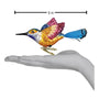Colorful glass hummingbird figurine held in a hand with a measurement label indicating 6 inches.