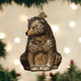 Vintage Bear-shaped Christmas ornament on a tree with lights in the background