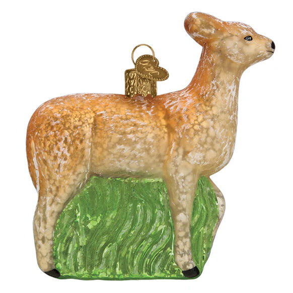 Glass ornament of a vintage deer with a green base on a white background